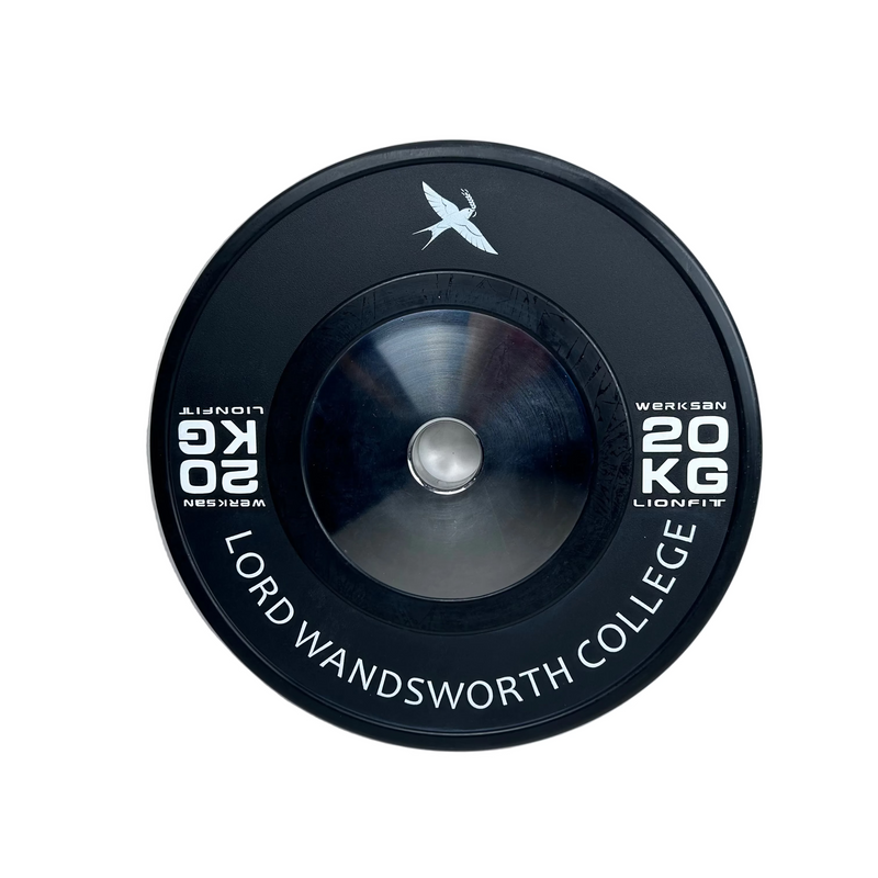 A black circular weight plate with a metallic silver centre, featuring white printed text that reads 'LORD WANDSWORTH COLLEGE 20 KG' and a white bird logo near the bottom, photographed on a light grey textured surface.